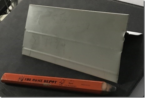 Photo of Scrap piece of drip edge with carpenter's pencil